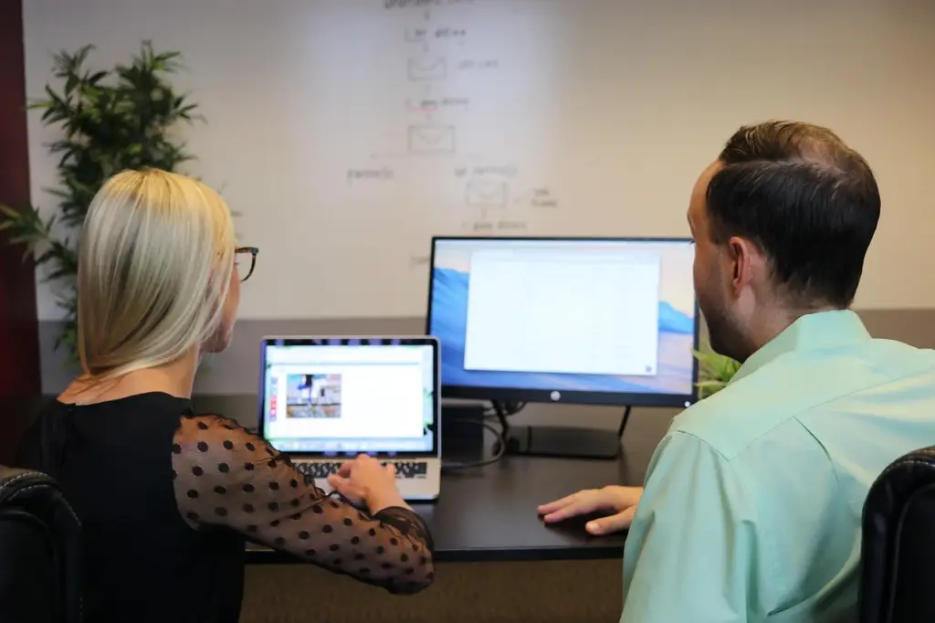Business team reviewing analytics on a whiteboard